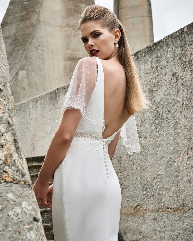 Bride looks over her shoulder wearing Elbeth Gillis