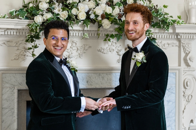 grooms tying the knot in front of fireplace