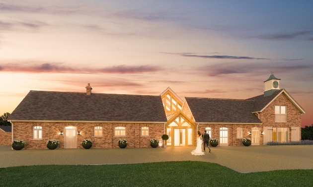 new build farm at night couple walking up drive to barn doors