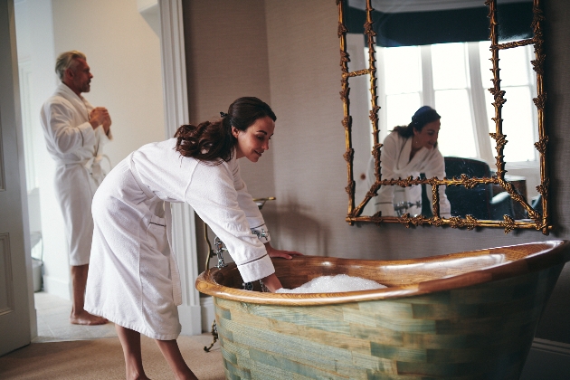 man and woman in bathrobes, woman running a bath