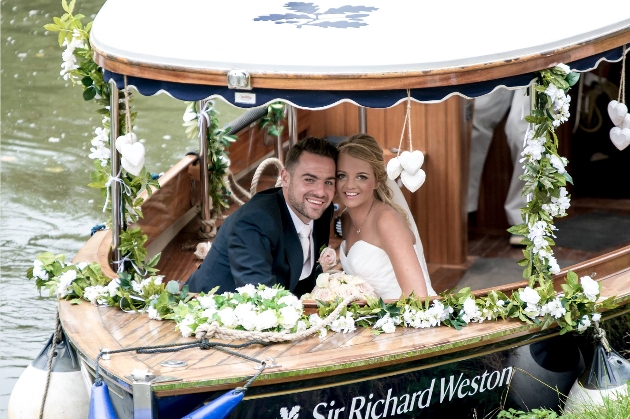 A couple sitting on a boat on their way to Weybourne House