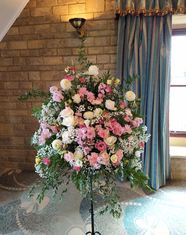 pedestal arrangement of white and pink flowers