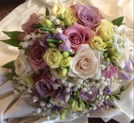 close up wedding bouquet of lilac and cream flowers