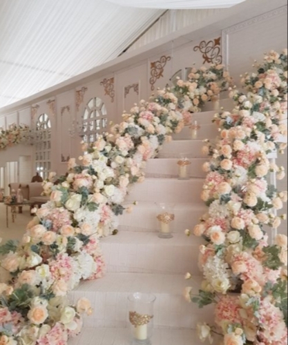pink and white luxury flowers going up a staircase both sides 