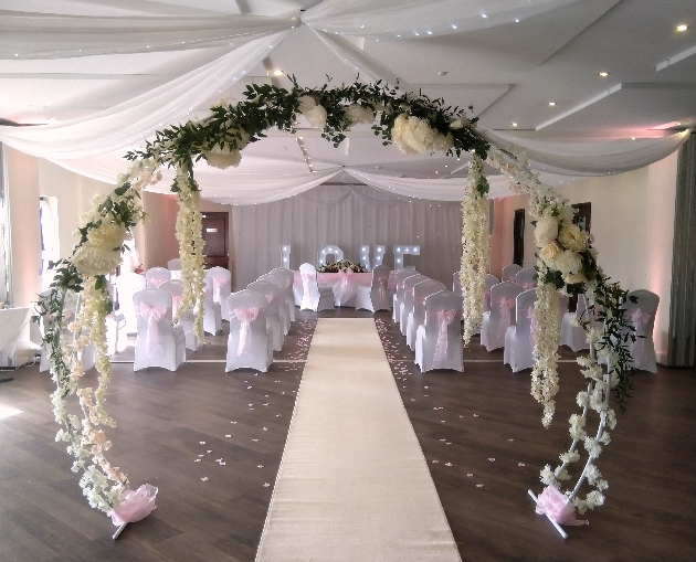 moongate arch of flowers in a reception room
