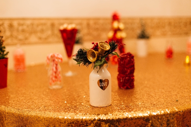 milk bottle on a table with a christmas decoration on top 