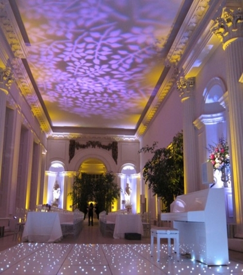 grand white room, lights off but purple uplighter making the room purple effect, led dancefloor 