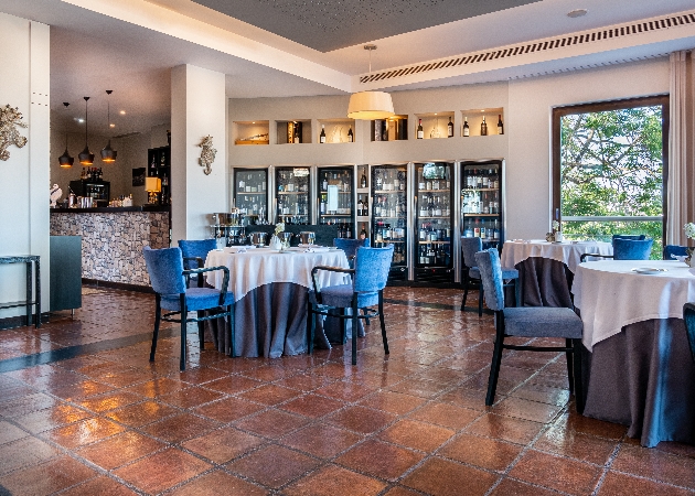 restaurant with terracotta paving slabs blue chairs and floor to ceiling wine fridge