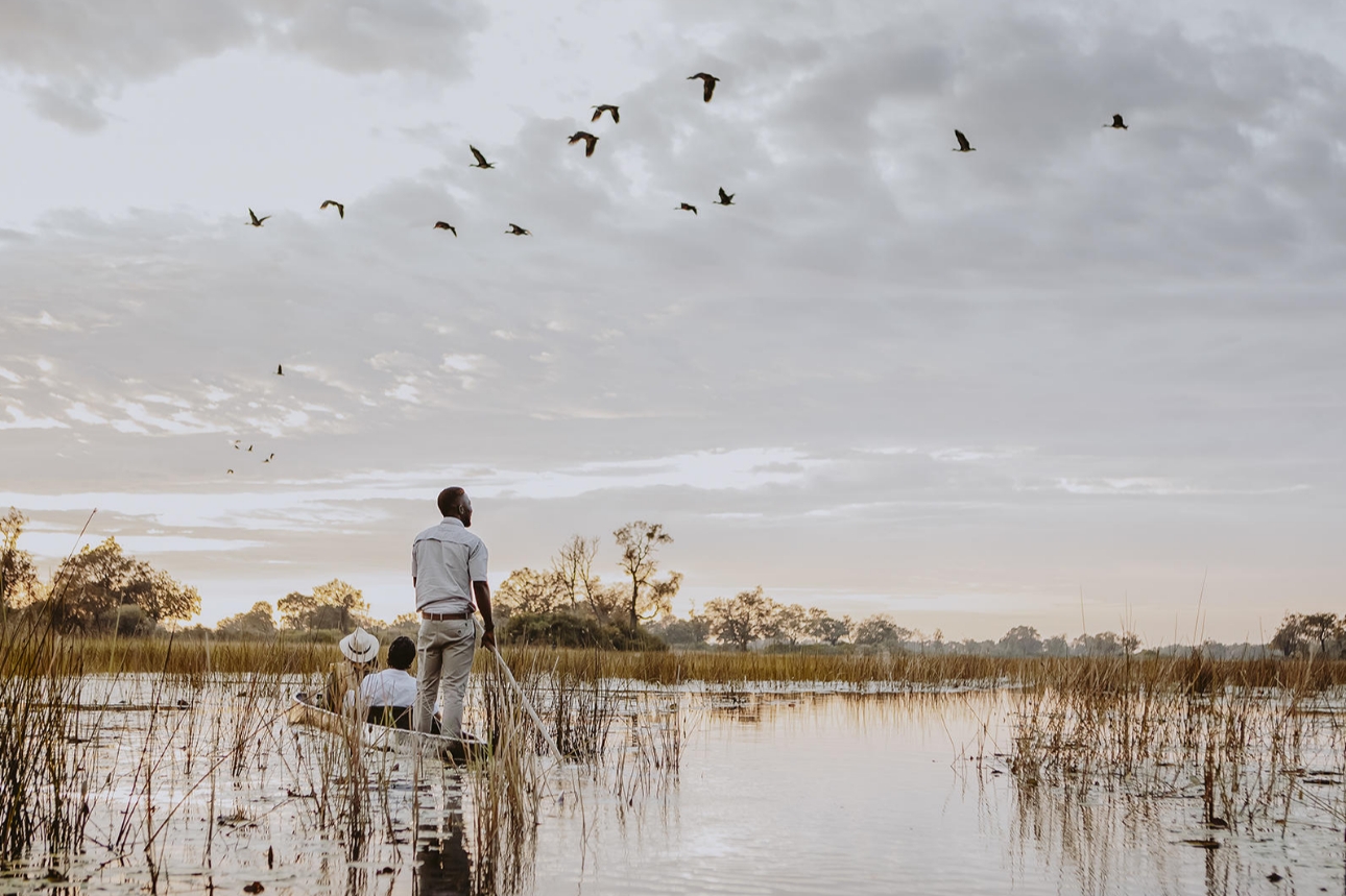 men on boat in lake on safari