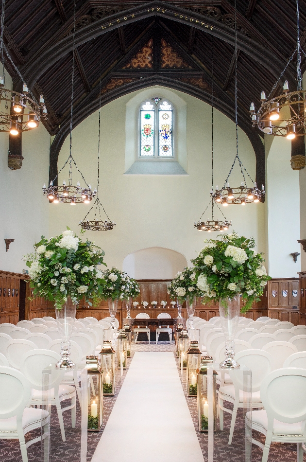 Historical main hall with wooden beams and panelling and coats of arms on the walls
