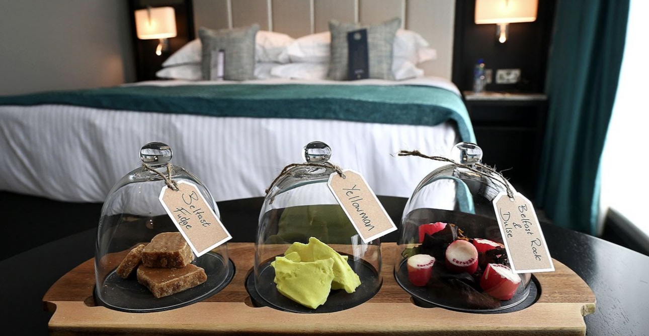 Sweets under three glass cloches in a hotel bedroom