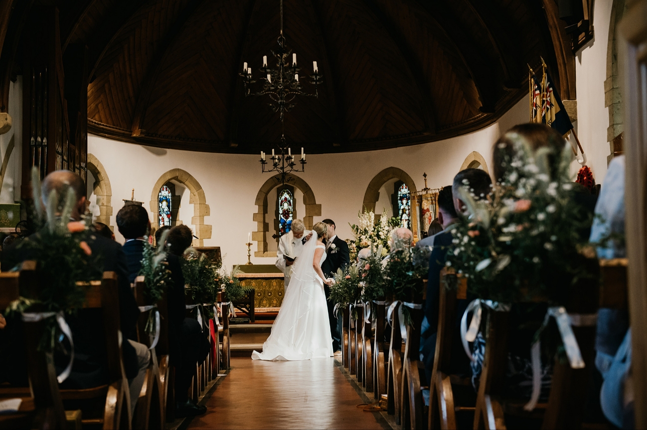 Newlyweds kiss at altar