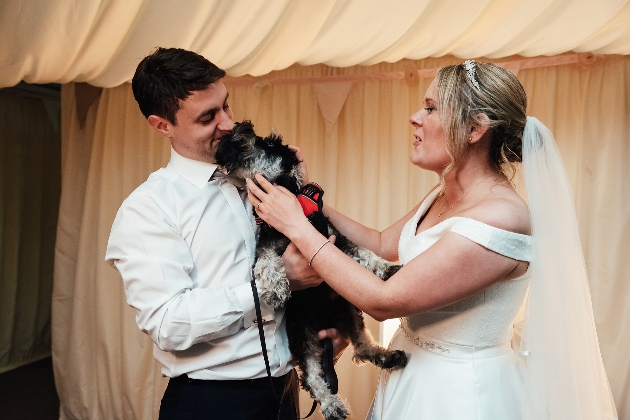 Couple holding dog