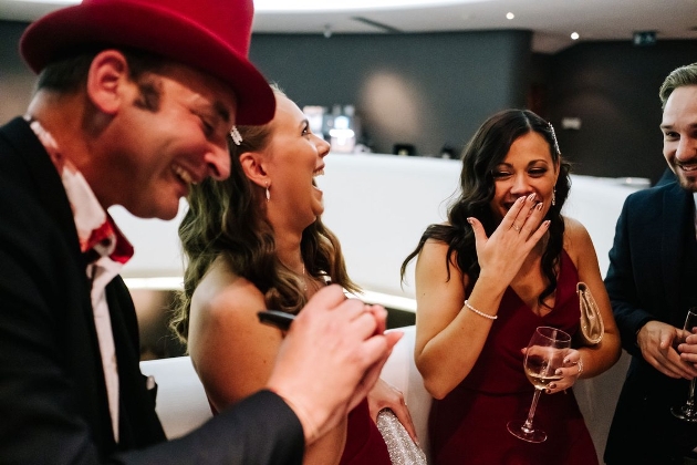 Two women laughing at a magic trick