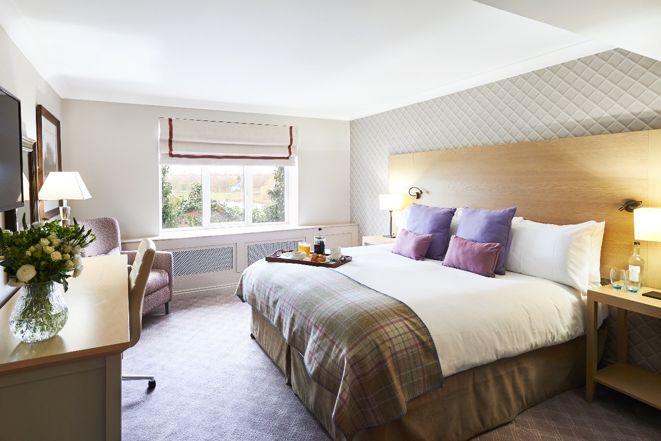 bedroom suit with bed desk armchair and window