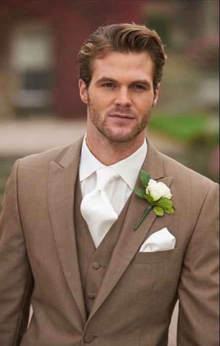 mousy brown haired male model in a light brown suit