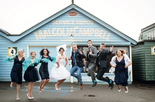 Wedding party jumping outside Brooklands Museum