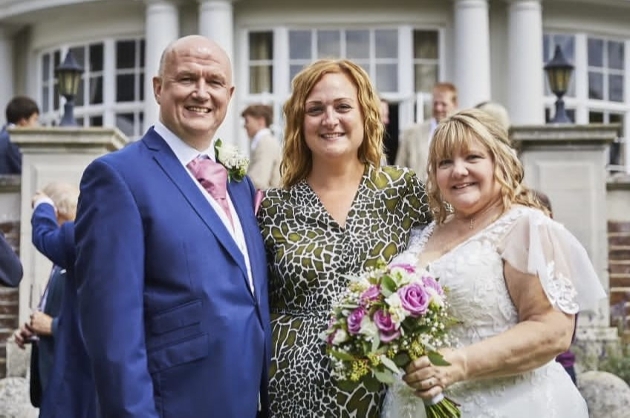 Teri Burvill with a bride and groom