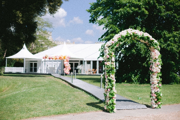 marquee in garden with flower arch