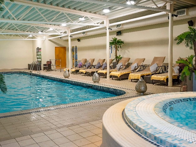 pool with atrium ceiling, sun loungers on side, jacuzzi