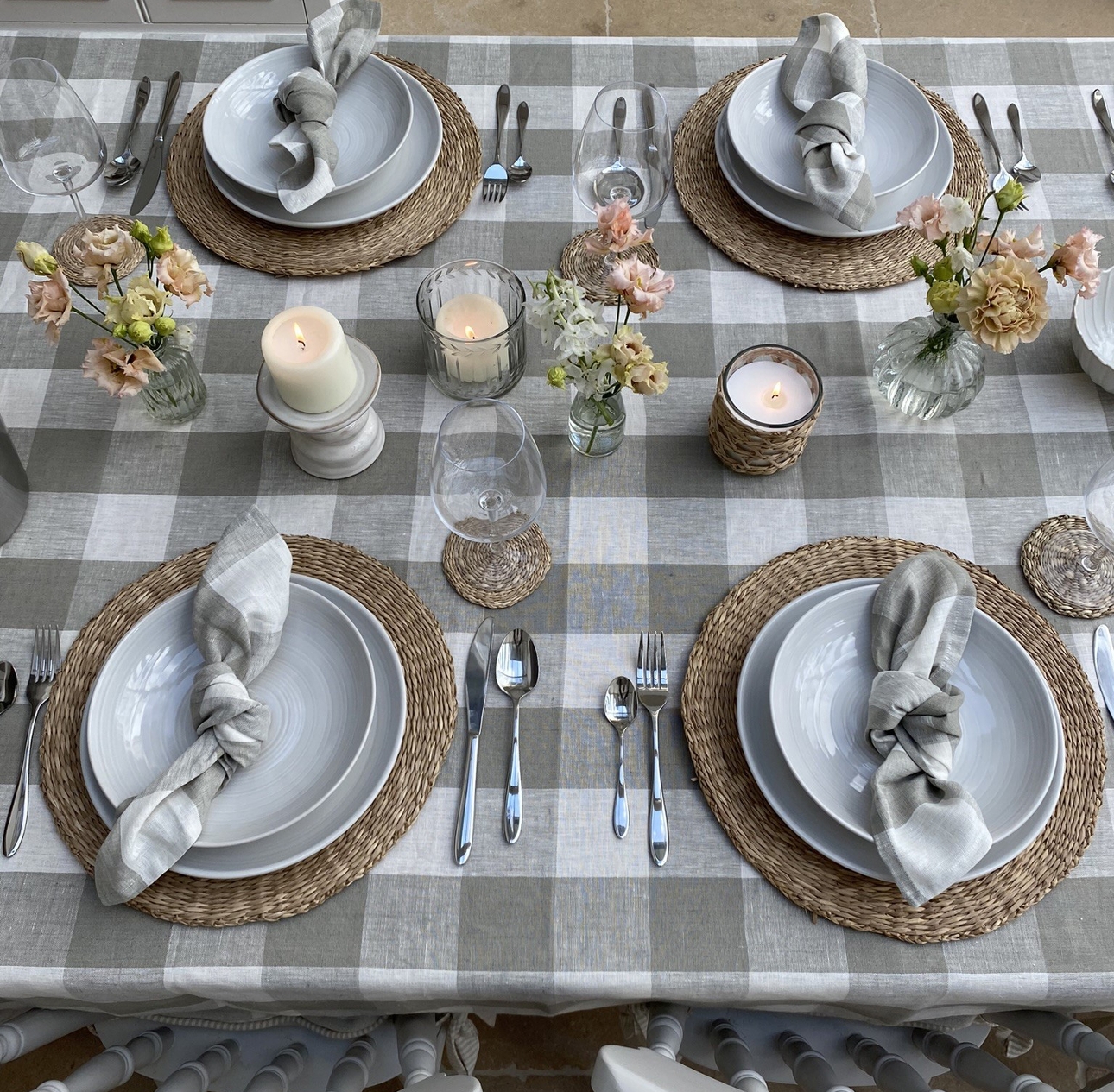 table laid out for dinner lots of plates cutlery glasses in country look