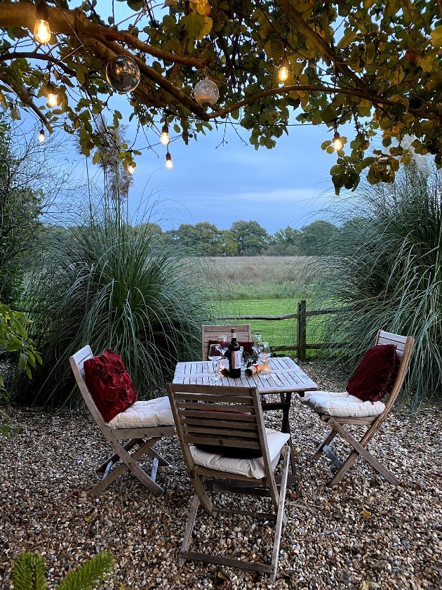 courtyard garden with table and chairs and views out to field