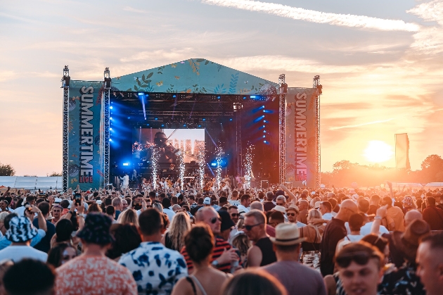 festival at sunset revellers dancing in front of stage