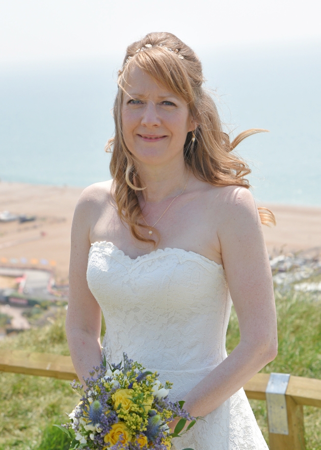 bride in wedding dress on her wedding day holding bouquet 