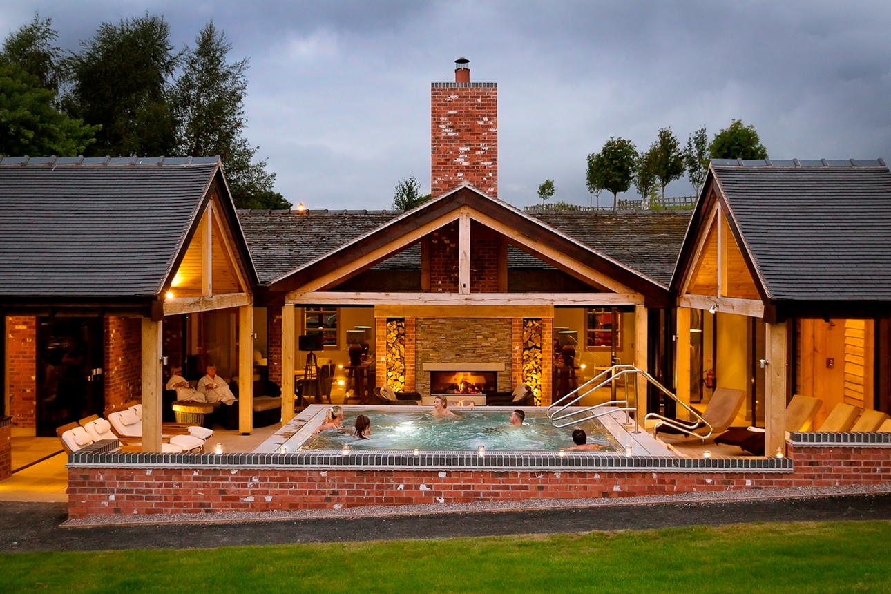 group of people in outdoor hot tub which is in the centre of a courtyard