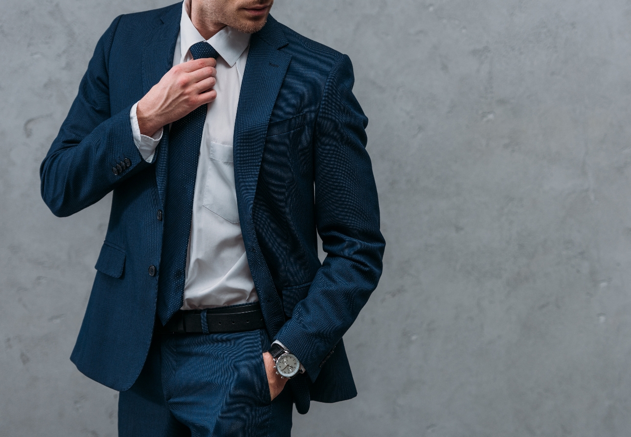 man in suit wearing watching with hand in his