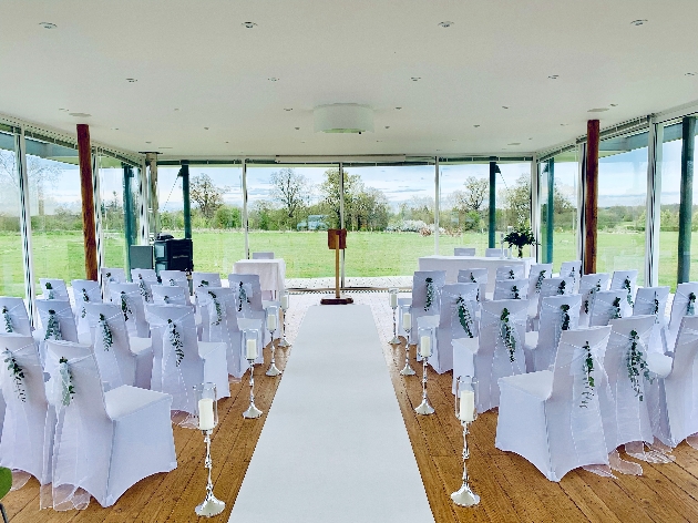 small room with completely window walls with ceremony chairs in middle