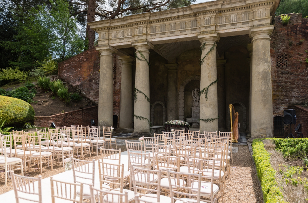 outside ceremony area, stone temple in style chairs outside looking toward it 