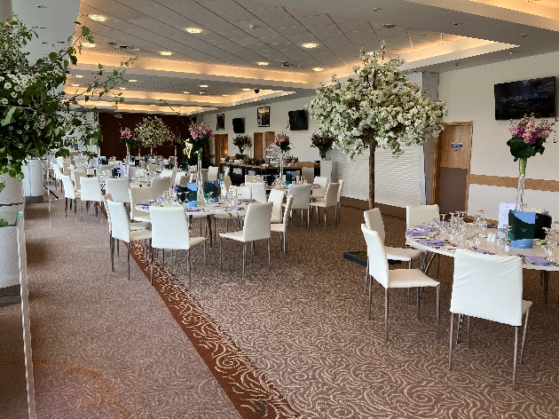 reception room interior cream walls, cream chairs, tables set up