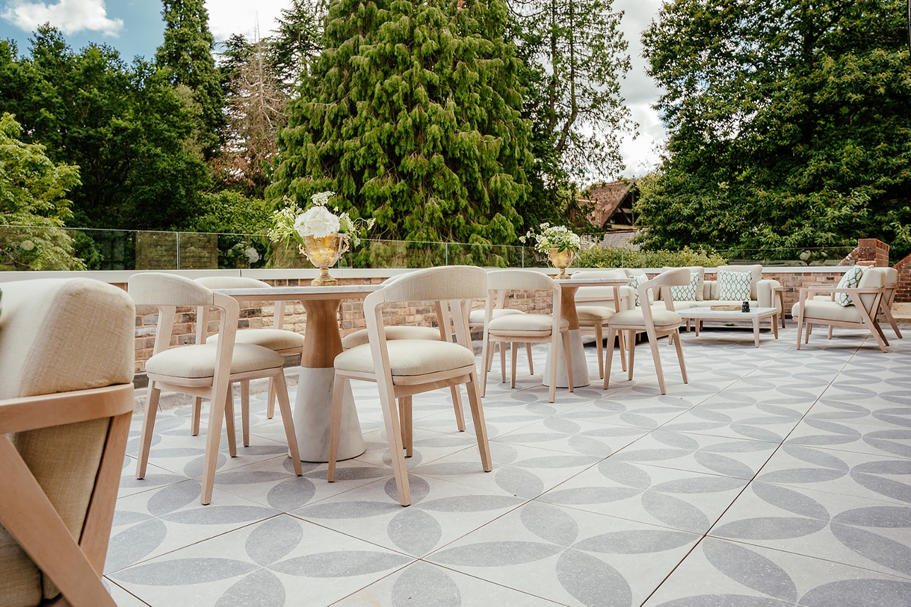 terrace with cream chairs and wooden tables