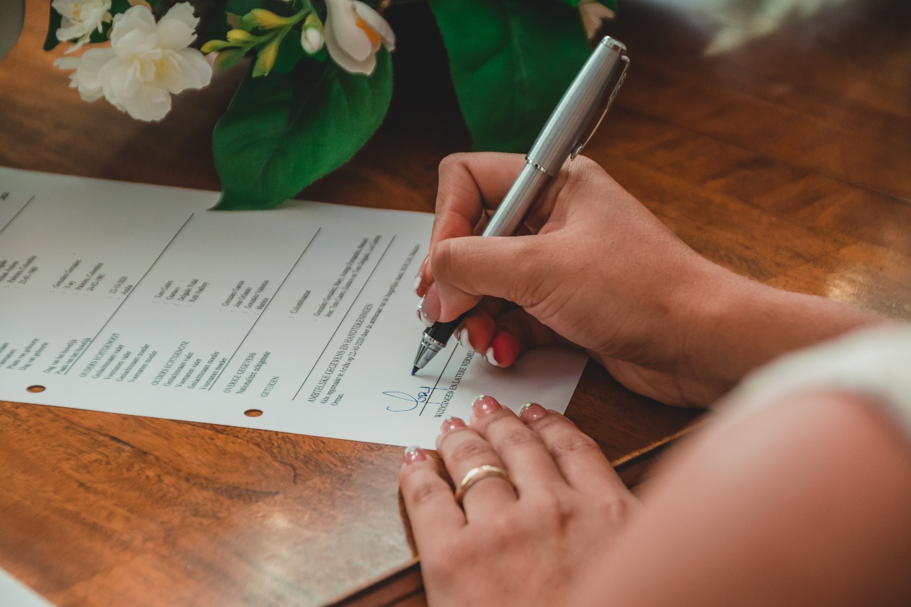 woman signing on a piece of paper