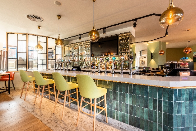 Holiday Inn London Sutton bar area blue tiles and green chairs glass hanging pendant lighting