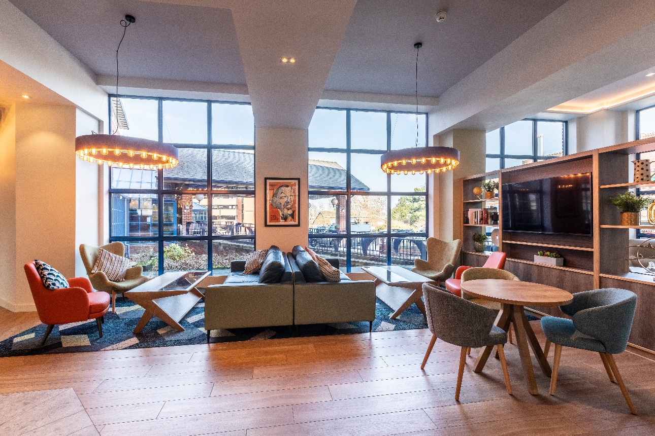 seating area, sofas, chairs, armchairs, big TV on shelving