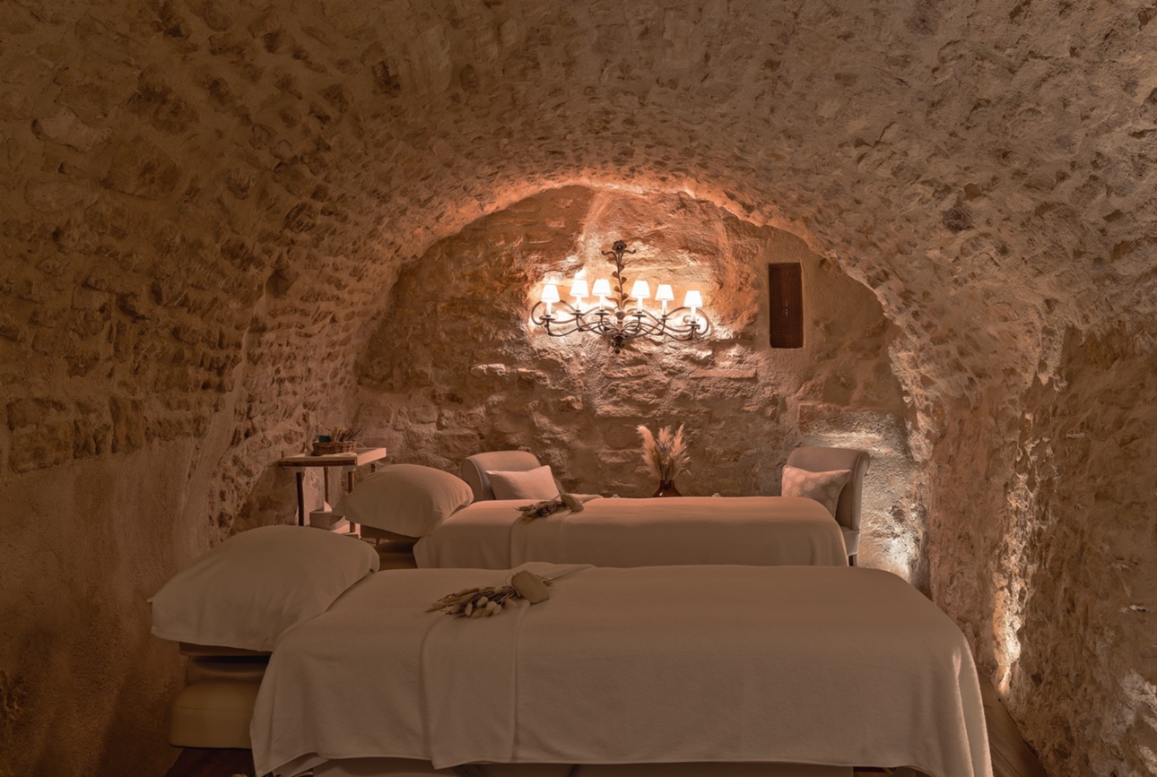 two spa beds under ground in cave like room softly lit