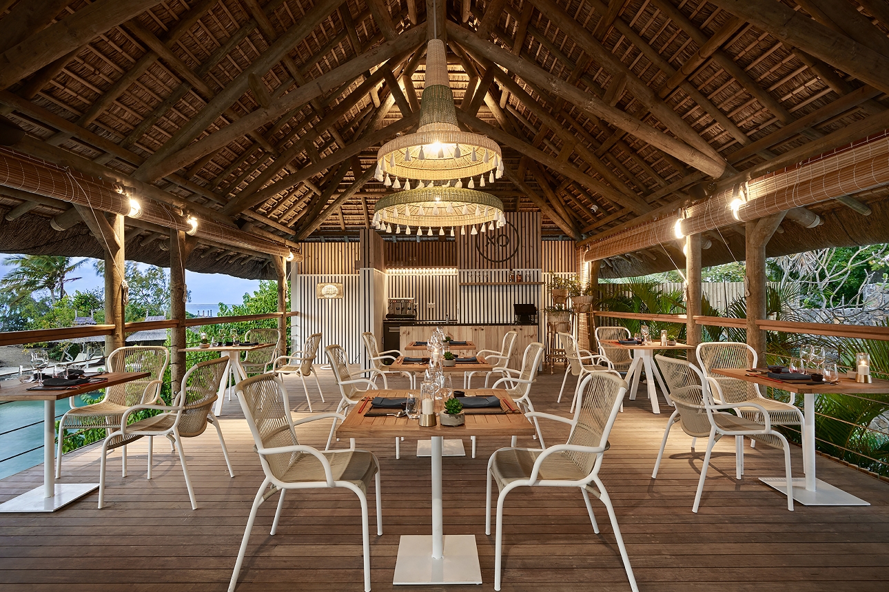 restaurant tables on raised terrace with roof