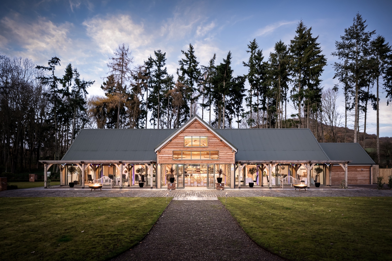 modern barn building in ground of venue at night