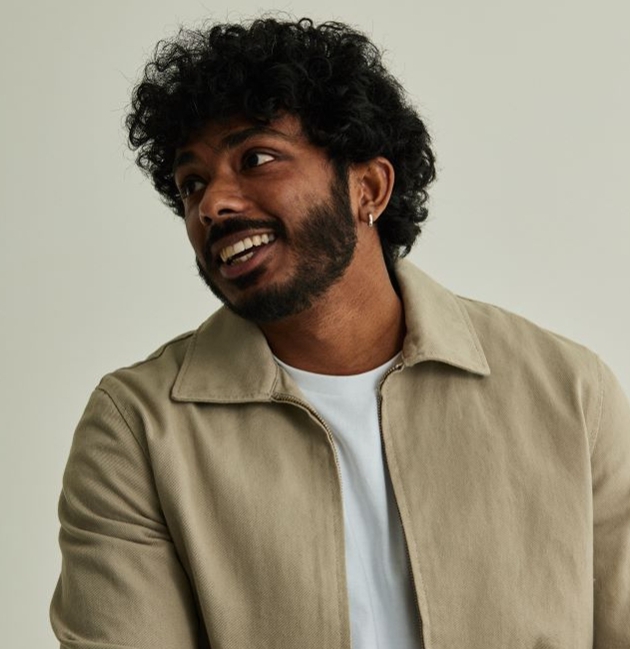 model in cream shirt with short curly hair