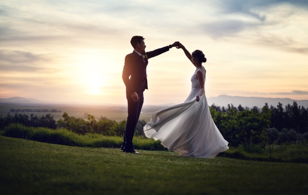 Bride and groom dancing in the sunset