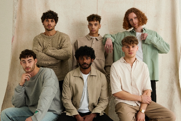 Six men with curly hair looking at the camera