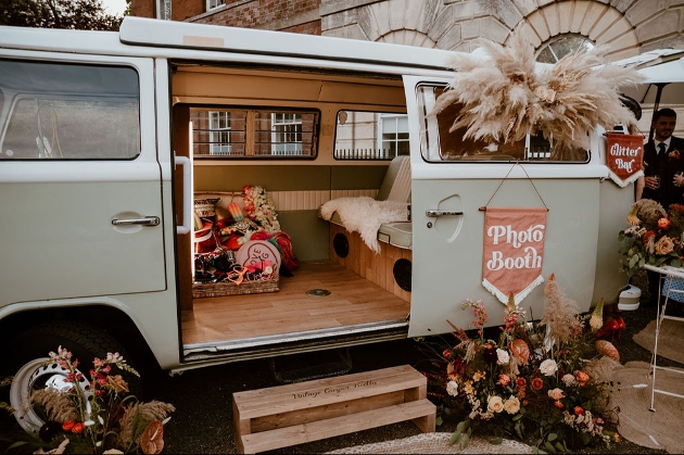 sage green VW camper decked out with sofa and props