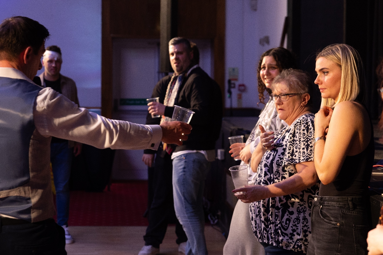 group of people on stage with a hypnotherapist 