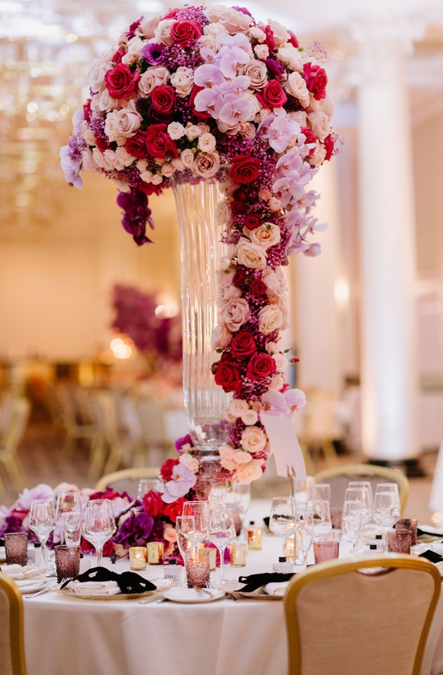 red and pink flowers in big display on table 