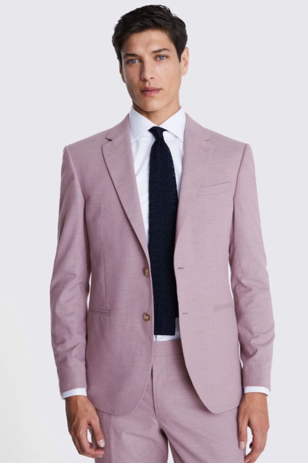 A man wearing a pink suit with a white shirt and black tie
