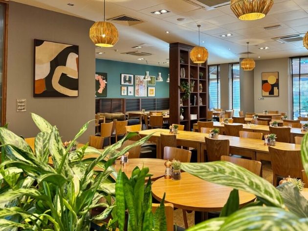 Inside image of restaurant with lots of greenery 