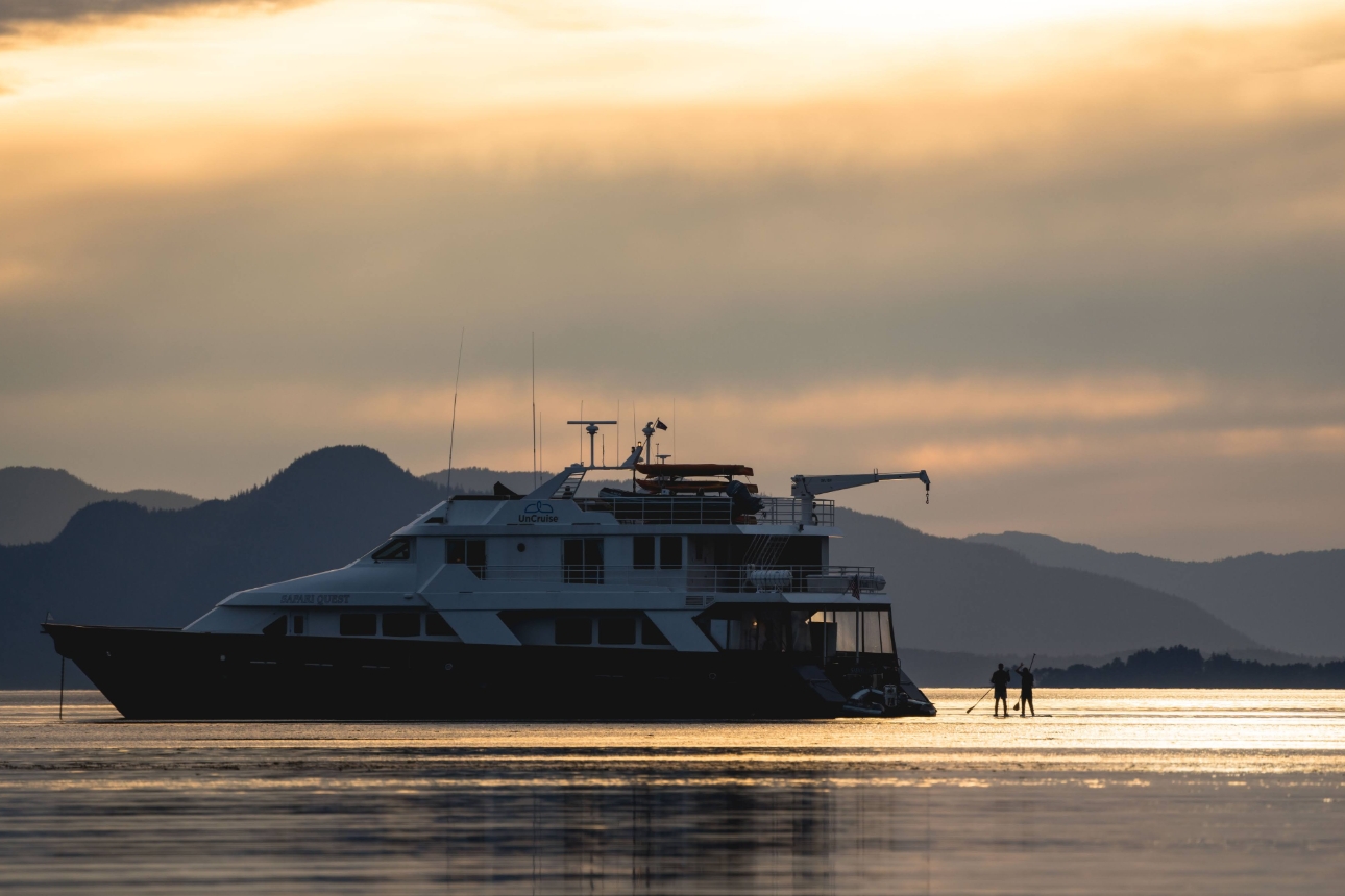 yacht on still water with two people in the ocean