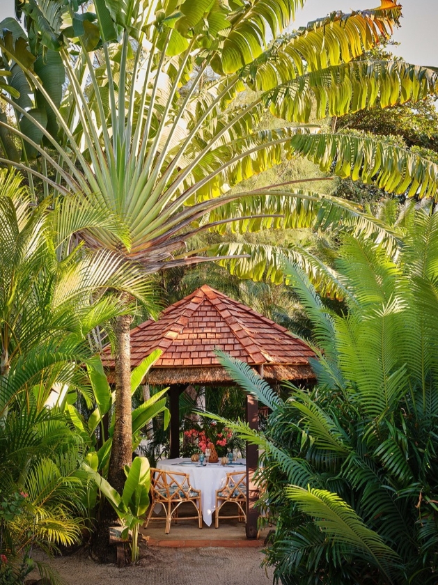intimate dining area in the middle of the woods under a gazebo 